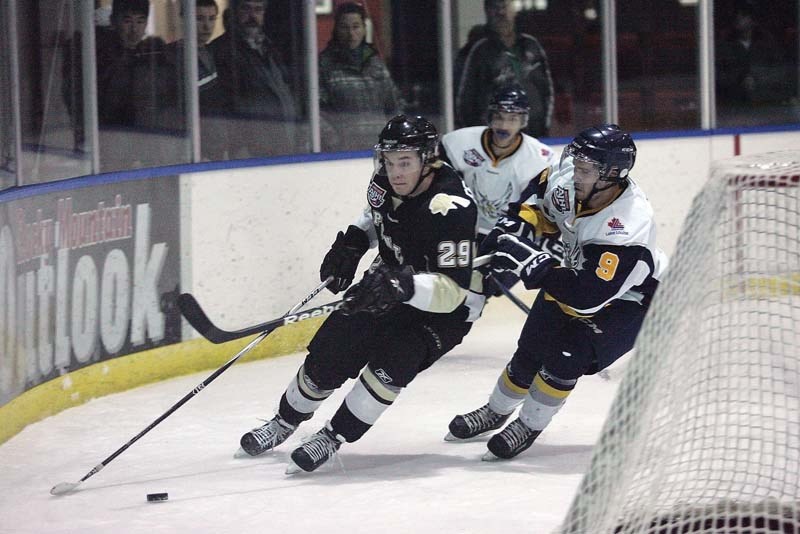Owen Ferguson looks to escape Eagles forward Steven Phee during the Pontiacs 5-4 overtime victory over Canmore at the Canmore Rec Centre Sunday.