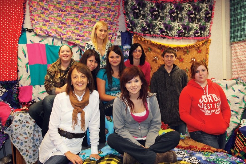 Students from Bonnyville Outreach School sewed 52 blankets to give to the homeless through the Bissell Centre in Edmonton. (Back) Meagan Travers. (Centre, left &#8211; right) 