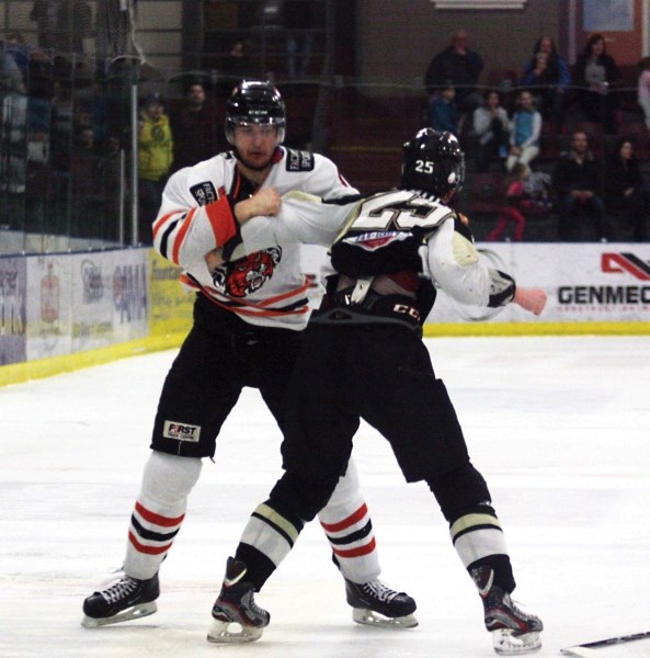 Pontiacs captain Locke Muller takes on the taller Ray Bell, after the Lloyd Bobcats defenceman laid a questionable hit to the head on Pontiacs forward Max Collins during