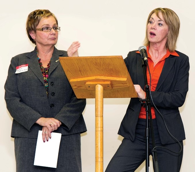 Minister of Environment and Sustainable Resource Development Diana McQueen (right), along with local PC MLA Genia Leskiw, responds to questions from the public during