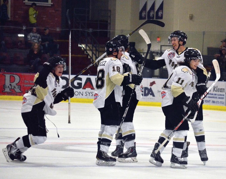 Pontiacs defenseman Ryan Black (left) celebrates a powerplay goal with teammates on Saturday night at the RJ Lalonde Arean. Bonnyville went on to win 4-2.