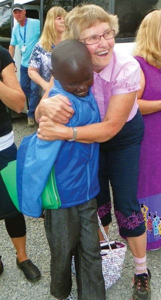 Iron River&#8217;s Mary Koziol meets 14-year-old David Kiarie, one of the children she sponsors, for the first time in person during her recent visit to Kenya.