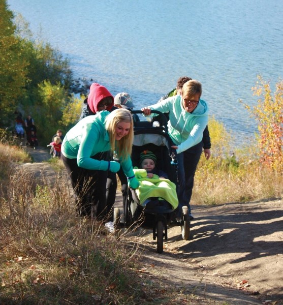 These women band together to ensure young Atticus Gillis and his stroller make it up the hill at Cold Lake Provincial Park during the Craig&#8217;s Cause pancreatic cancer