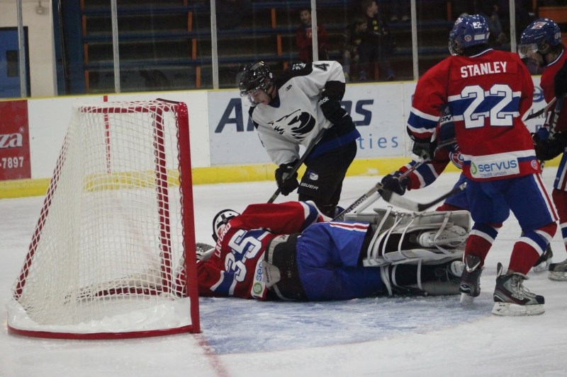 Cold Lake Ice forward Ryan Rancier attempts to force the puck home in the team&#8217;s opening game victory over the St. Paul Canadiens. The Ice rallied against a