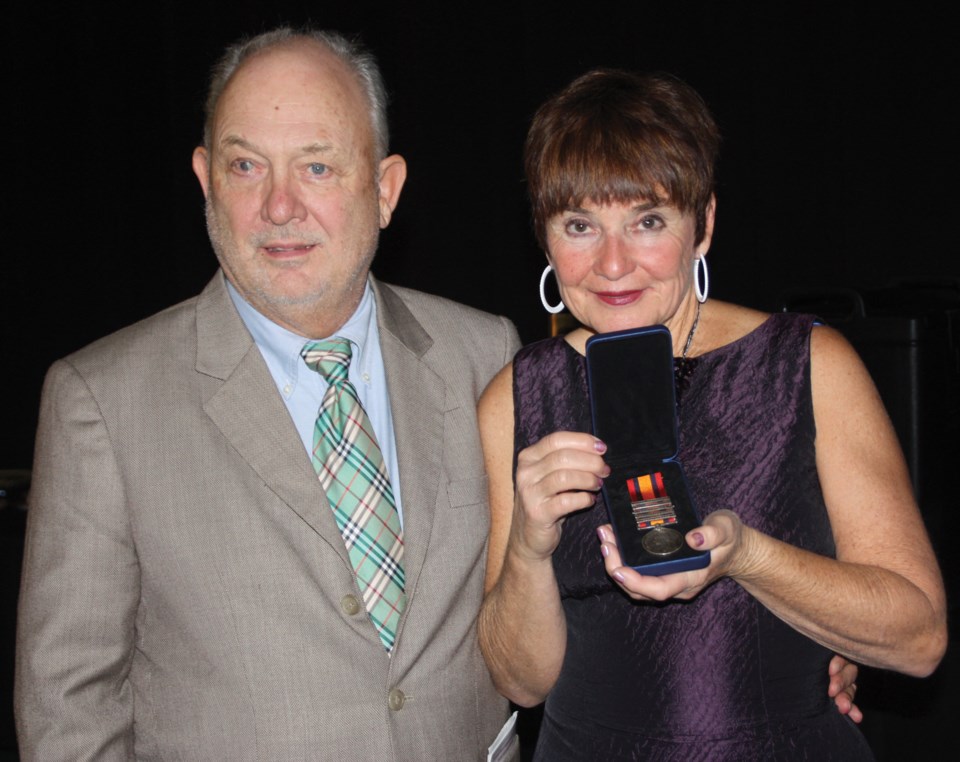 Lee and Penny Jensen pose with the medal.
