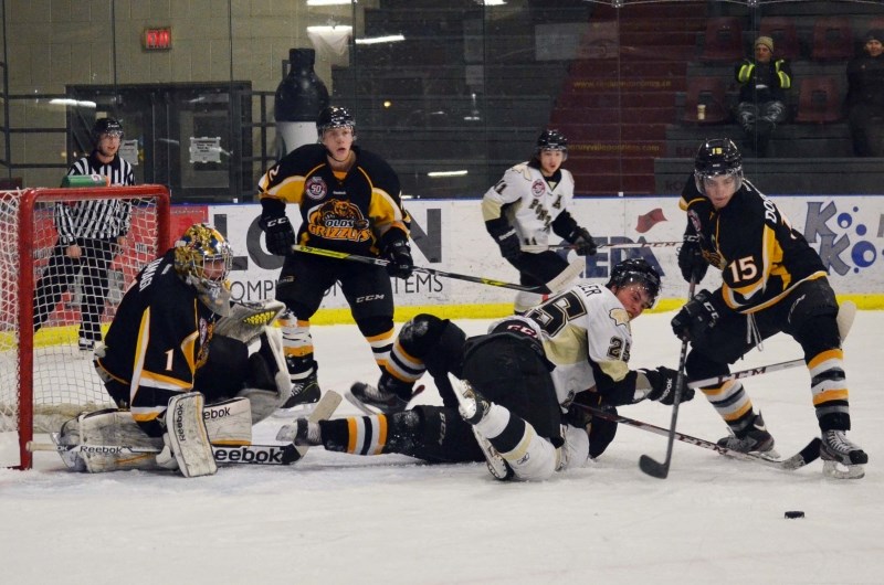 Pontiacs captain Locke Muller (#25) falls down during a mad scramble in fron of the Olds net in the third period on Nov. 9. The Pontiacs edged the Grizzlys 4-3 in a shootout.