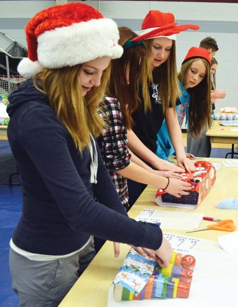 Students and other members of the community gathered at BCHS on Dec. 19 to wrap gifts for the Santa&#8217;s Elves program. A total of 352 kids in the region will recieve