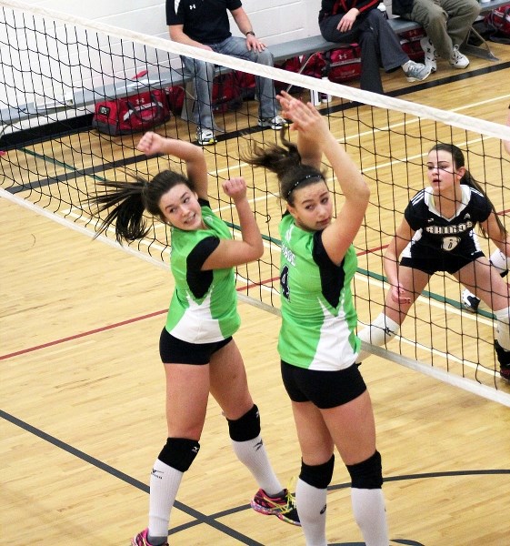 Power hitter Harlee Cameron and middle blocker Nicole Bourget make a block during a match earlier this season. Both Bourget and Cameron, who hail from Bonnyville, have been