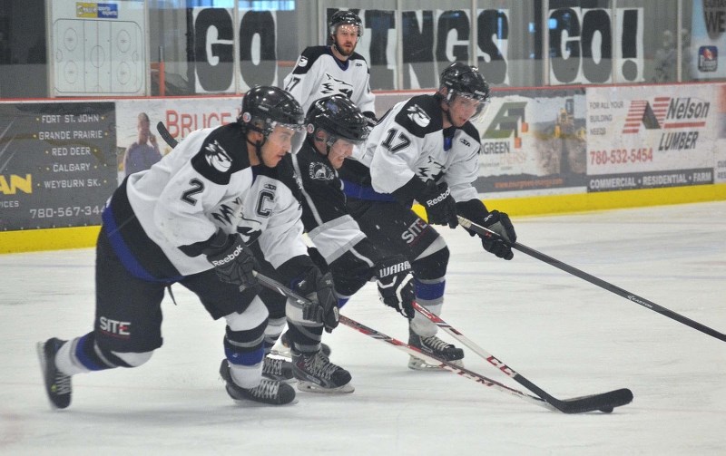 Cold Lake captain Dallas Ansell battles for a loose puck in a game against the Grande Prairie JDA Kings.