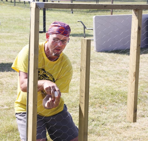 Craig Wenzel tries to move an egg through a chicken wire maze during the final challenge of Survivor Lakeland on Saturday afternoon. Wenzel was eventually crowned the lone