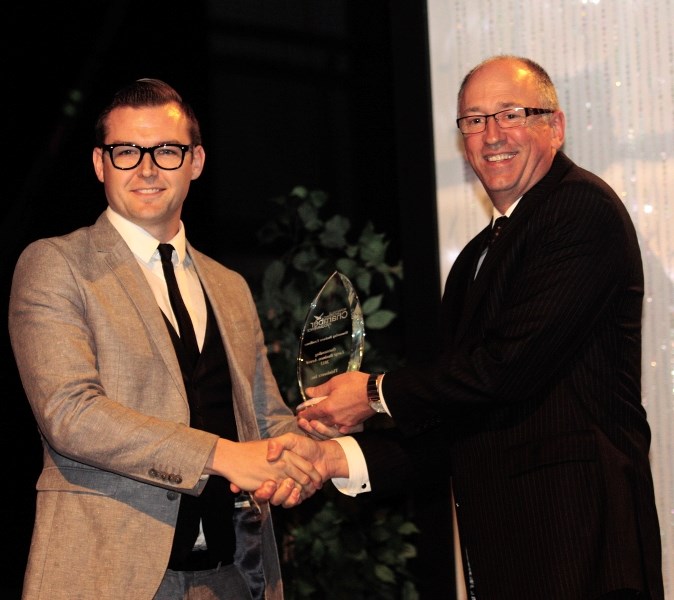 Kelsey Brennan, owner of local business Thinkwerx accepts his award for best overall large business at last year&#8217;s Business of the Year awards ceremony in Bonnyville.