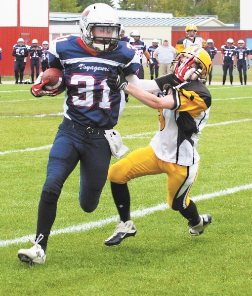 Bonnyville Voyageur Reid Skrypichayko stiff arms an opponent on the way to his second quarter touchdown against the visiting Wainwright Commandos on Friday evening.