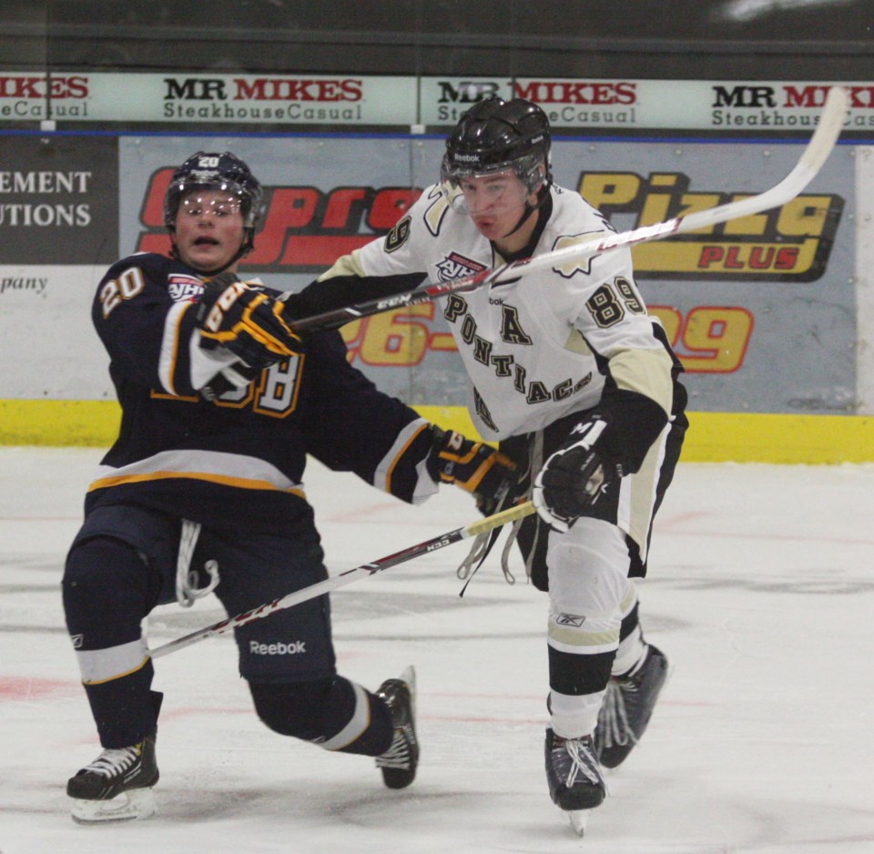 Bonnyville Jr. A Pontiacs forward Steenn Pasichnuk pushes past Fort McMurray&#8217;s Danton Ayotte during AJHL action on Sept. 24.