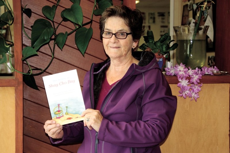 Local author Mereline Griffith shows off her new book The Secret of Shay Cho Bay.