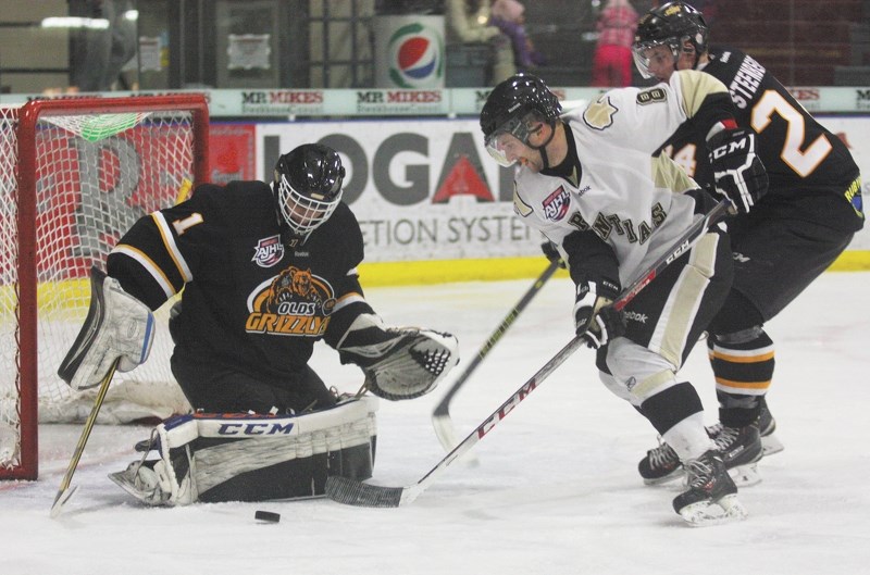 Bonnyville forward Luke Mahura swats at a loose puck infront of the Olds goal. The Pontiacs defeated the Grizzlys 4-1.