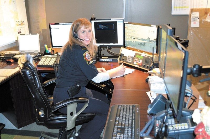 Dispatcher at the 9-1-1 Centre in Bonnyville Annamarie Wirachowsky, gives first responders a tour during the Christmas Open House.
