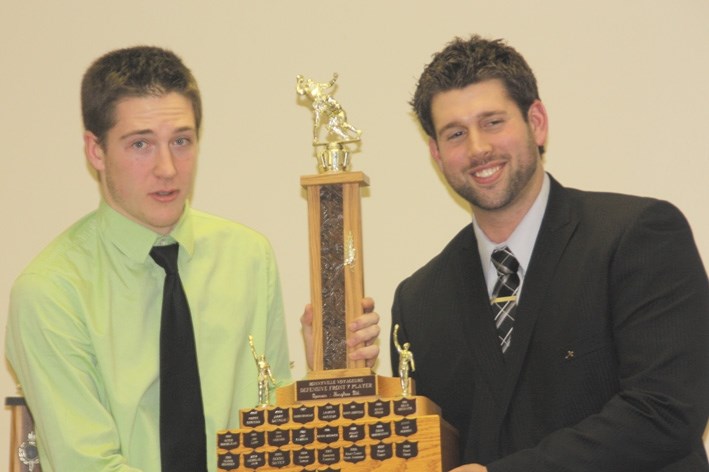 Voyageurs Cole Kulczycki accepts his Defensive Front 7 player of the year award at the annual awards banquet.