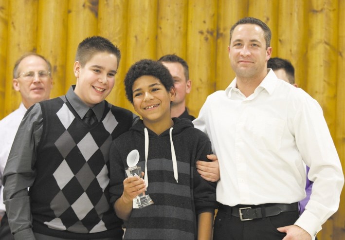 Former Renegades Cadence Gislason poses with Heart and Soul player of the year award winner Cedric McCullam (middle) and Head Coach Kevin Sartain.