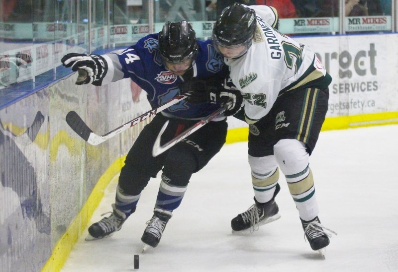 Bonnyville&#8217;s Dylan McCombie and Okotoks Rhett Gardner battle for a lose puck.