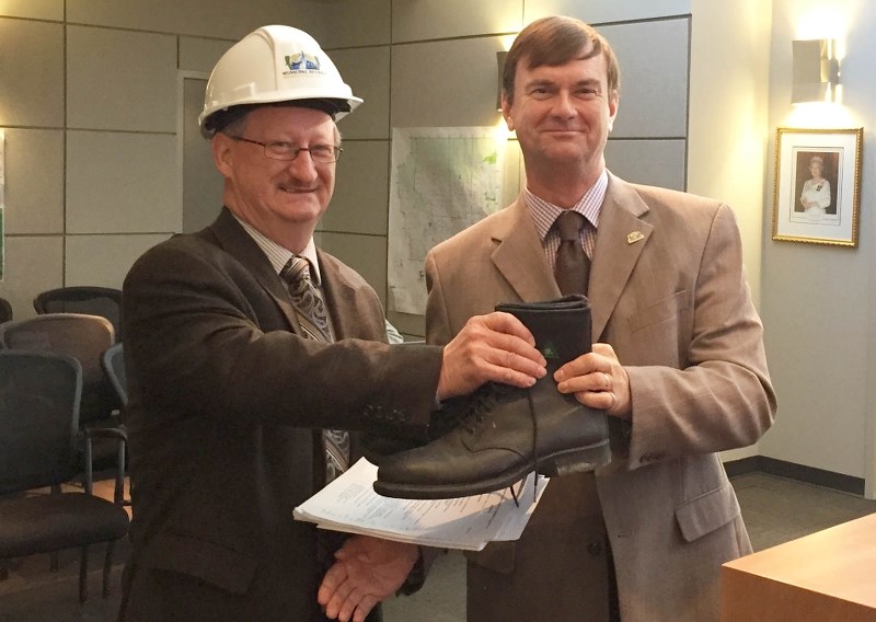 MD Director of Finance Gordon Fullerton was handed a pair of shoes by MD CAO Chris Cambridge after presenting the 205 budget.