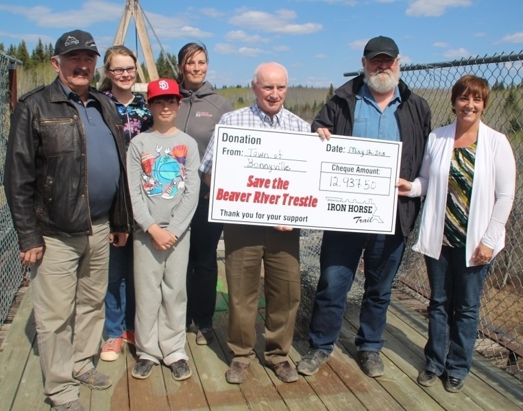 Town of Bonnyville Coun. Ray Prevost hands a cheque for almost $13,000 to representatives from Northeast Municorr and the Riverland Recreational Society as part of the