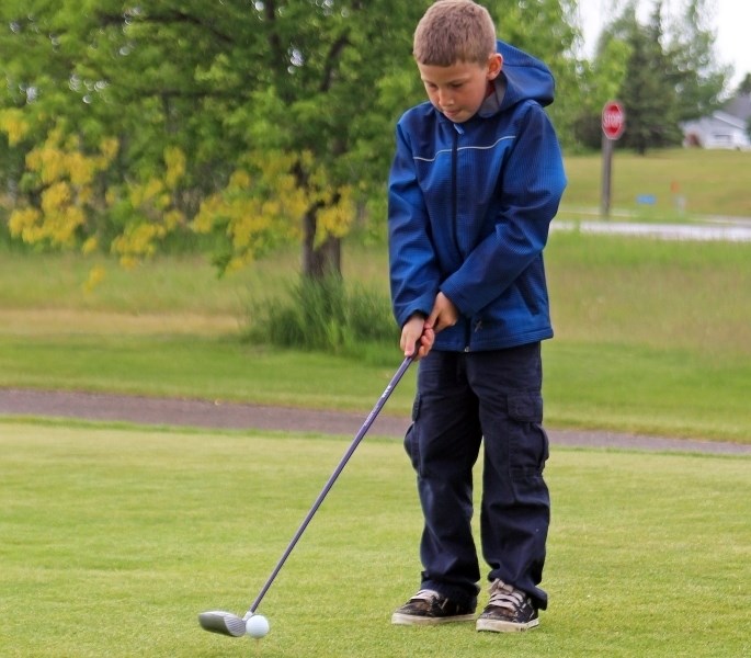 Justin Bellisle lines up his shot at the annual Kleinmann Cup Charity Golf Tournament.