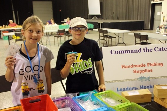Biz Kid Jaxx Gale (right) and Gracie Cook (left) sell Gale&#8217;s handmade fishing supplies during the weekly Farmers&#8217; Market in Cold Lake.