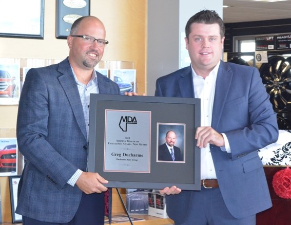 Greg Ducharme (left) was presented with the 2015 Dealer of Excellence Award on Sept. 3.