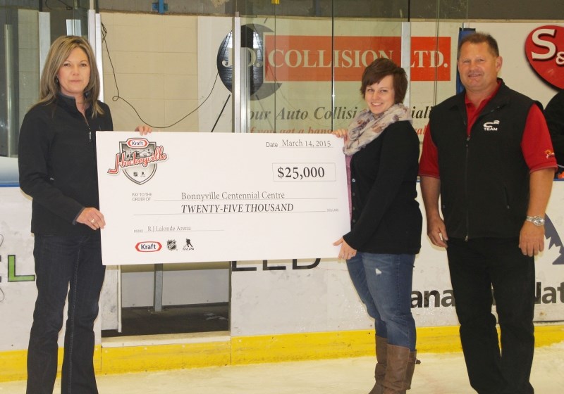 Amanda Cumby (middle) and Gary Krawchuk (right) of the C2 were presented with a $25,000 cheque for finishing as a finalist in Kraft Hockeyville.