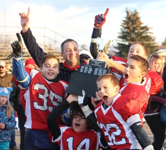 Renegades captains and head coach Kevin Sartain celebrate a provincial championship victory over Red Deer.