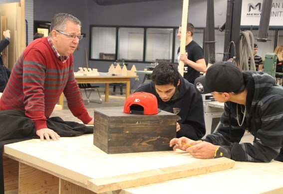 Teacher Raymond Froud (left) assists some students in the new workshop at Cold Lake Middle School.
