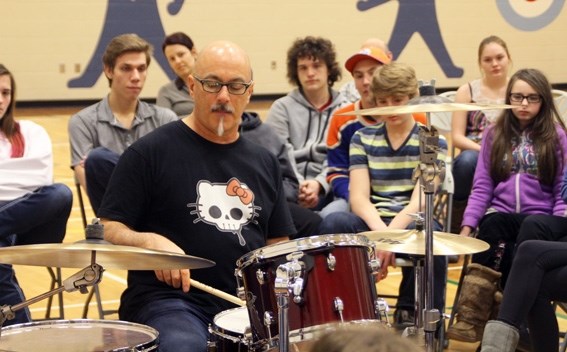 Mitch Dorge of the Crash Test Dummies plays the drums for students at école des Beaux-Lacs at the conclusion of his presentation last week. Dorge was in the area to visit six 