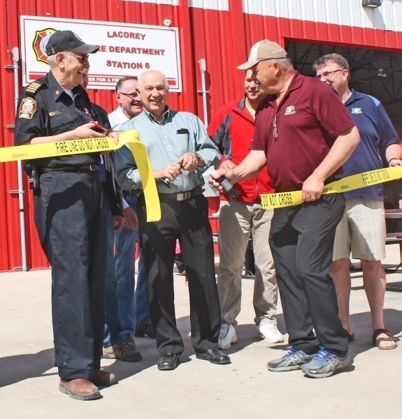 La Corey Station Fire Chief Al Donald (left) cut the ribbon on the new fire hall with Reeve Ed Rondeau (centre) and Coun. Mike Krywiak.