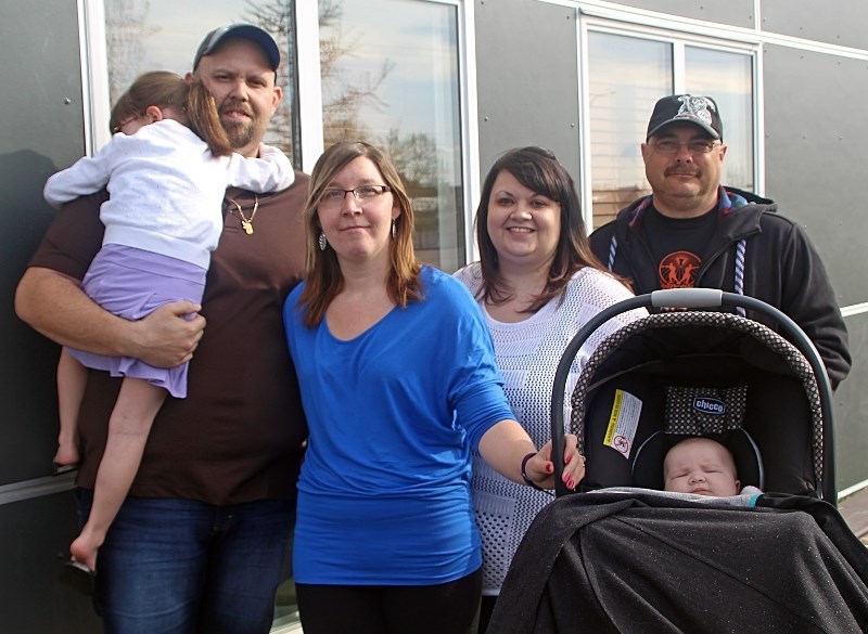 (left) Craig and Jessica Haynes, with their two children, and (right) Tara and Chris Sutton, came to Bonnyville after evacuating their homes in For McMurray.