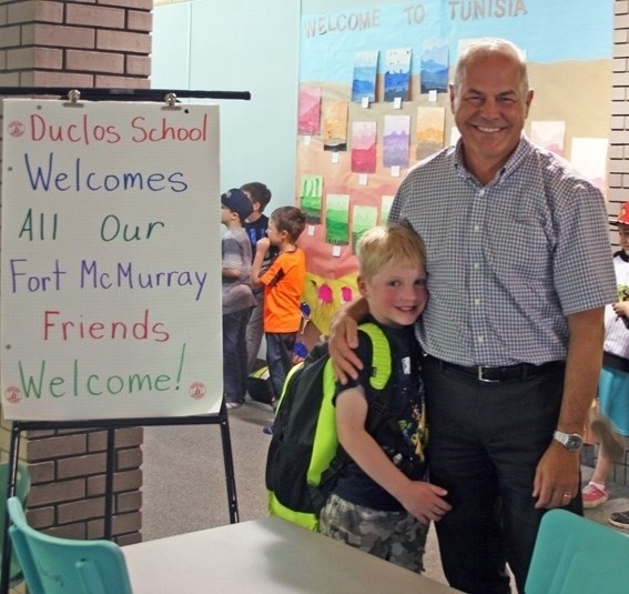 Fort McMurray evacuee Sebastien Griffith, 6, stands with Duclos principal Richard Cameron. Griffith is attending Duclos while his family is staying in Bonnyville.