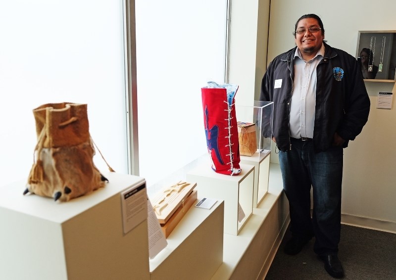 Jamie John-Kehewin stands with his pieces at the Carrying On Aboriginal Art Exhibit in Edmonton. Currently enrolled at Portage College in Lac La Biche, John-Kehewin has ties