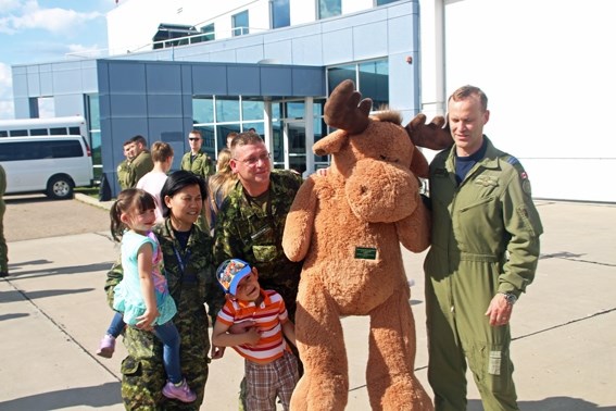A stuffed moose is presened to Lt. Col. Mike &#8220;Moose&#8221; Grover by Capt. Manivon &#8220;Dog Bite&#8221; Morrison and her husband Sgt. Michael Morrison alongside their 