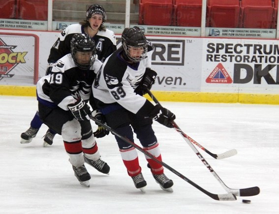 John Pashniak (89) tries to play keep away from Shaunessy Brown-Usher (19) during the intrasquad game, which was part of the Ice training camp.