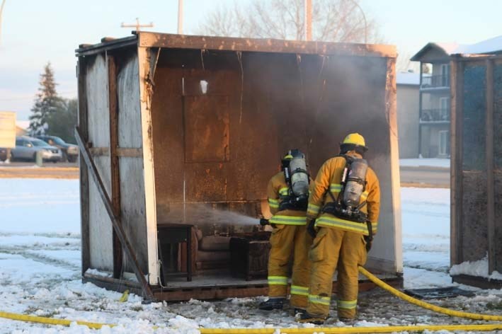 Firefighters put out the flames from a demonstration at the open house.