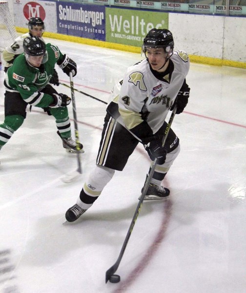 Derek Brown brings the puck out from behind the net in the second period on Saturday as they took on the Drayton Valley Thunder for their second home game of the weekend.