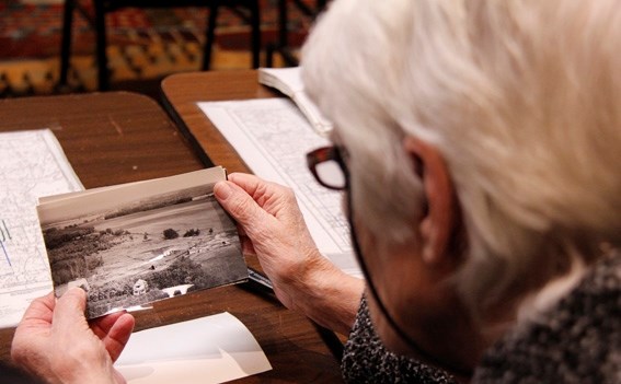Roberta Daniels looks over old photographs of some of the areas she has known for years. Her and her hsband were on the hunt for photos of the family farm.