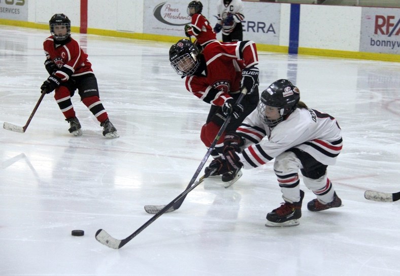 Faith Donovan reaches for the puck in a game versus Rosetown during the Alberta Hockey Day: Celebrating the Female Game event at the C2 on Saturday.
