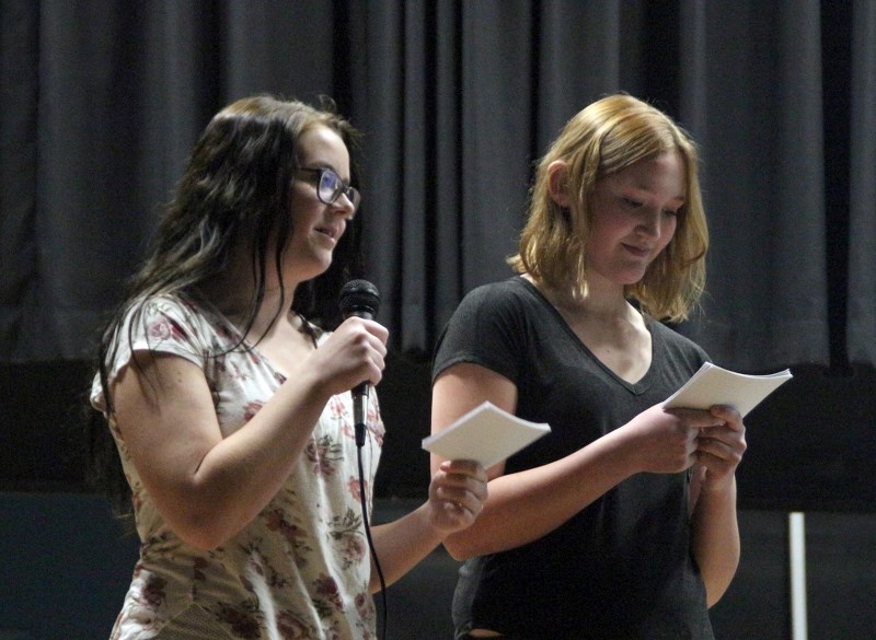 Ryanne Wenzel and Payge Satek, along with Sarah Harasem and Mason Ward, make a presentation about the local fire department and its impact on the community.