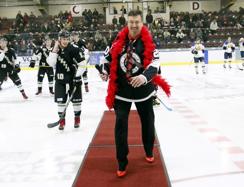 Mayor Gene Sobolewski makes his way off of the ice in his red high heels, as he joins 19 other men taking part in the first Walk a Mile in Her Shoes event on Sunday, Feb. 26.