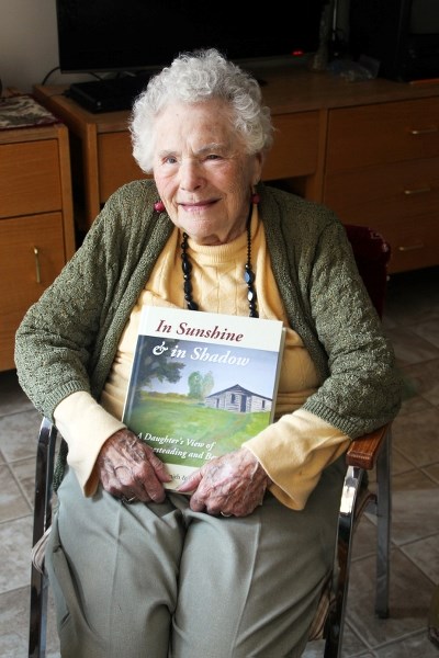 Cathie Smith sits with her memoir, In Sunshine and in Shadow, in her room at BonnyLodge. Smith, who will be 98 this summer, recently published the book with the help of her