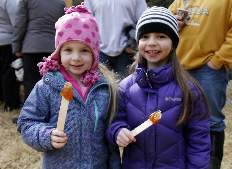 Enjoying their toffee on the snow at the annual La Cabane &aacute; Sucre du Nord are Solange, left, and her sister Sophie Dsnoyers.