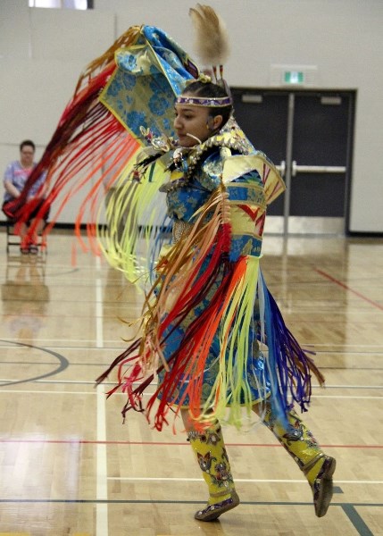 Jayda Gadwa performs the fancy shawl dance during their stop at Notre Dame High School.