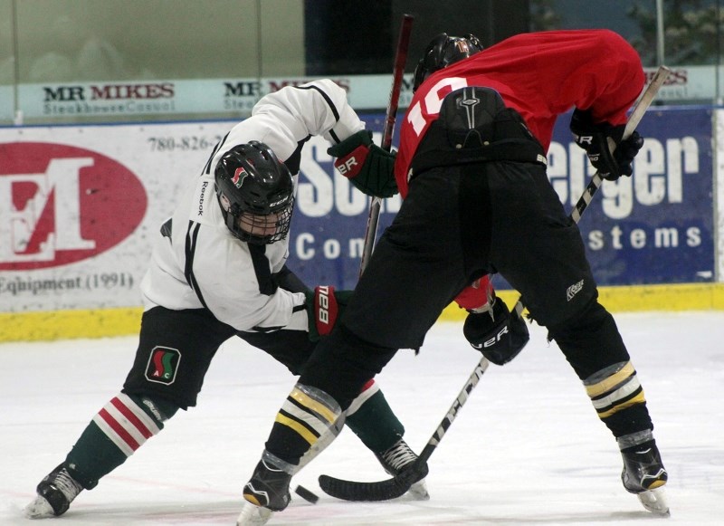 Kyle Lamont of the white team and Graeme Byrkes of the black team face-off during the prospects camp.