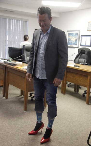 Mayor Craig Copeland sports a pair of red high heels after committing to the event.