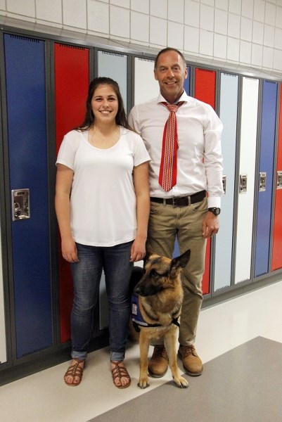 Nikki stands proudly beside Grade 12 student Rachel Moraweitz and handler Darrel MacDonald.